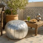 Silver leather round ottoman styled with tea set and lanterns - handcrafted metallic floor pouf for patio
