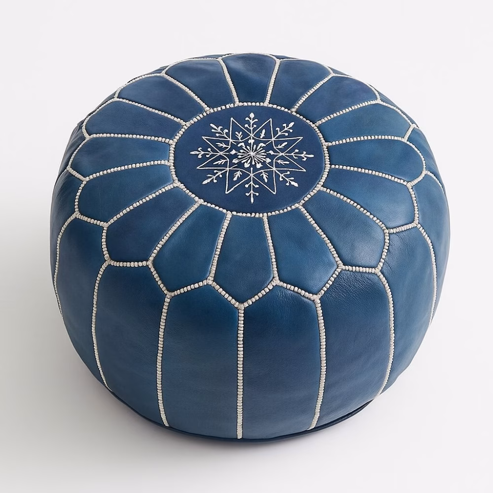 Blue leather pouf with white geometric stitching pattern