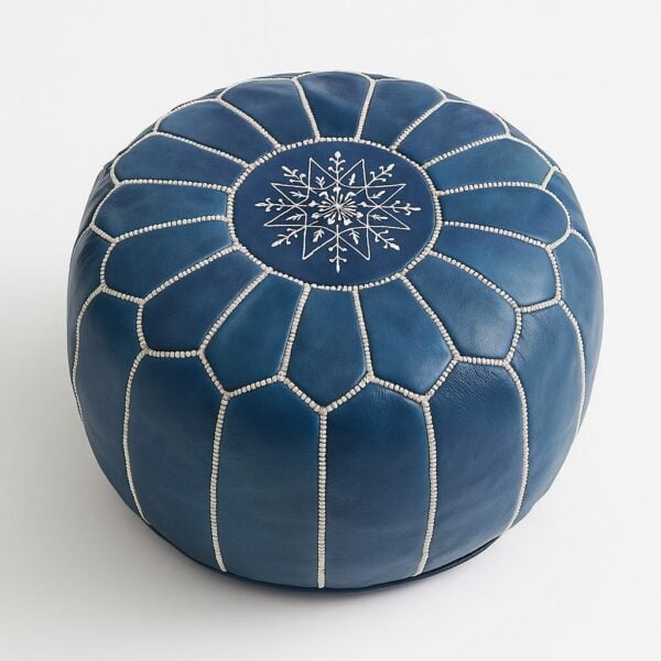 Blue leather pouf with white geometric stitching pattern