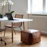 Square leather ottoman footstool under modern dining table in bright home office workspace