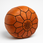 Close-up of natural leather pouf ottoman with hand-stitched Moroccan geometric design.