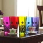 Set of six jewel-tone henna tea cups with black hand-painted mandala motifs in a decorative row