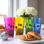Colored tea cups with white roses and croissants