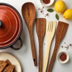 Six piece lemon wood kitchenware 12" set with spoons and fork beside red pot with lemons and spices