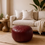 Deep Red Leather Pouf Round accenting a modern living room with beige sofa and neutral decor.