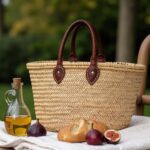 Straw tote bag picnic basket with leather handles - French market bag outdoors with bread and figs