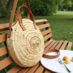 Close-up of round straw bag herringbone weave pattern, handcrafted circular basket with brown leather handles
