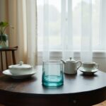 Blue and green handblown wine glasses on a rustic wood table in a lifestyle setting