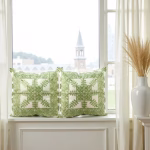 Geometric embroidered cushion covers by window