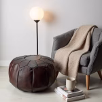 Leather pouf ottoman with reading lamp and throw blanket