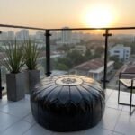 Black leather floor ottoman on balcony at sunset - versatile handcrafted pouf for indoor outdoor use