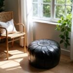 Black leather floor ottoman near window - round pouf with star medallion perfect for modern home decor