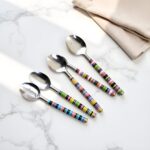 Ceramic tea spoons with vibrant multicolor striped handles displayed on marble surface, artisan-crafted tableware
