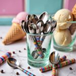 Ceramic tea spoons set in glass container with ice cream cones, multicolor striped handles, kitchen display