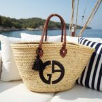 Designer straw tote bag on sailboat with black monogram and brown leather straps