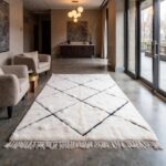 Handwoven Beni Ourain rug with Berber diamond design in modern entryway featuring concrete floors and large windows