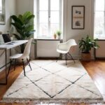 White wool Beni Ourain rug with black diamond lines in bright home office with modern chairs and hardwood flooring