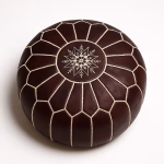Handmade leather pouf dark brown with intricate white embroidered star design and geometric panel stitching