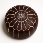 Dark brown leather floor ottoman with handcrafted star embroidery and geometric stitching detail