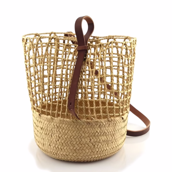 Handwoven straw backpack with leather details on white background