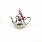 Silver tea set arranged for traditional ceremony with steaming teapot and prepared tea glasses on decorative tray