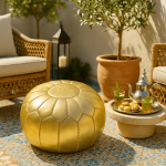 Champagne gold leather floor ottoman pouf on patio with Moroccan tea set and decorative lantern