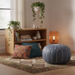 Leather Pouf Gray in a cozy bohemian nook with patterned rug, cushions, and plants.