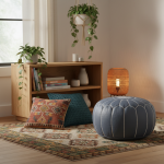 Leather Pouf Gray in a cozy bohemian nook with patterned rug, cushions, and plants.