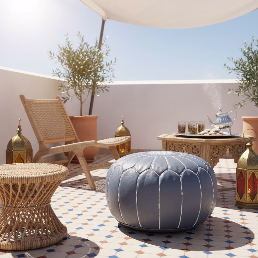 Leather Pouf Gray on a Moroccan terrace with lanterns, woven chair, and traditional tea set.