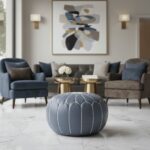 Gray leather round ottoman pouf in elegant living room with modern furniture and abstract art