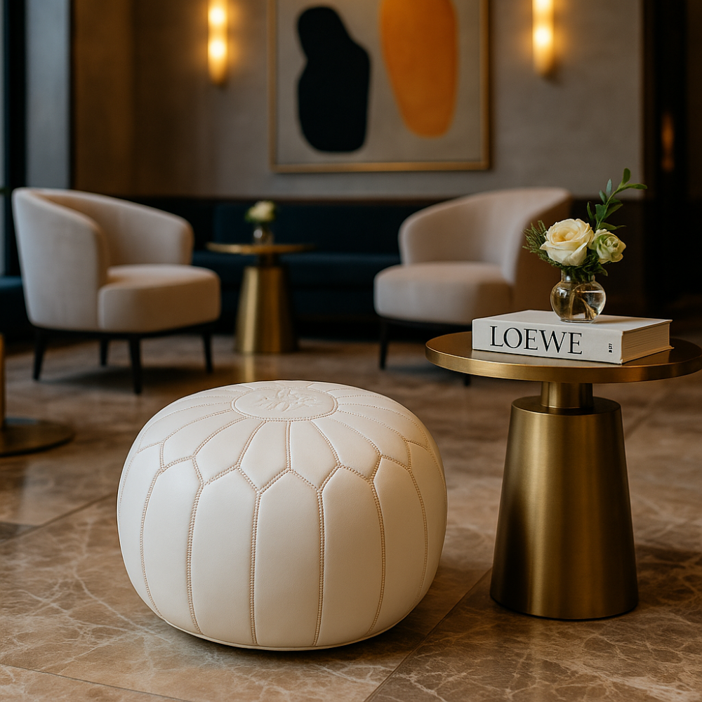 Leather Pouf White in an elegant hotel lobby with gold accents and modern armchairs.