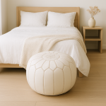 Leather Pouf White placed at the foot of a minimalist bed in a serene bedroom.
