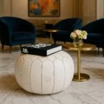 Handcrafted white leather round ottoman with star embroidery on marble floor in elegant living room