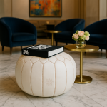 Leather Pouf White styled in a modern lounge with a book and golden side tables.