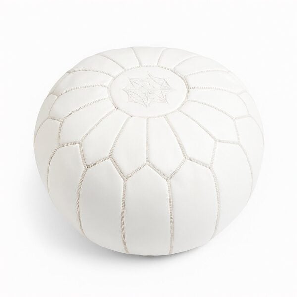 White leather round ottoman with hand-embroidered star design and geometric stitching on white background