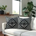 Black embroidered pillow covers styled with monstera plant