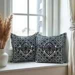 Embroidered pillow covers by bright window