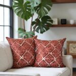 Modern living room with terracotta geometric pillow covers on white sofa, tropical plant decor