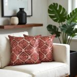 Geometric pillow covers featuring terracotta leather appliqué on light sofa, contemporary interior design