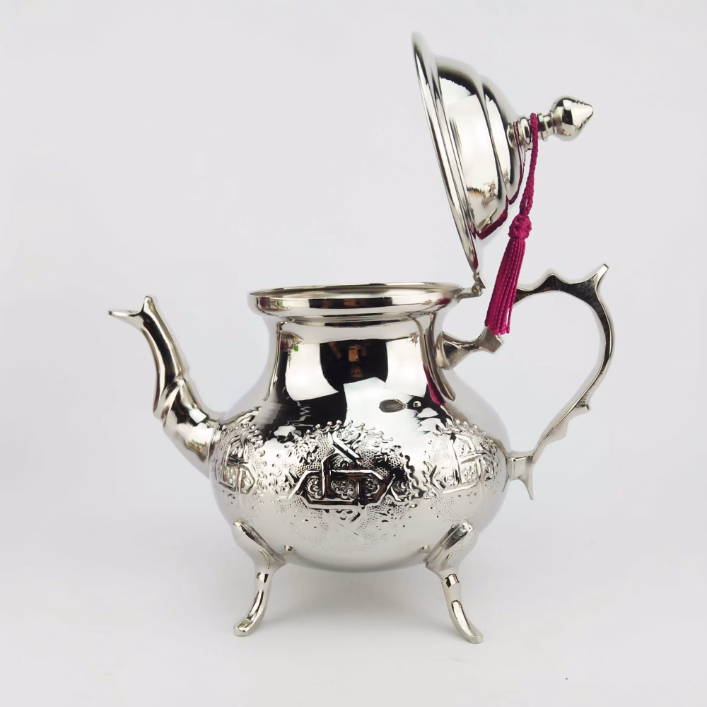 Side view of hand-engraved silver teapot