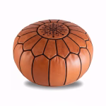 Natural leather pouf ottoman with Moroccan embroidery, displayed on a plain white background.
