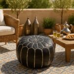 Round black leather floor ottoman 21 inch with white embroidery on outdoor patio beside Moroccan tea set