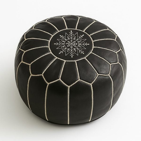 Overhead view of black Moroccan leather pouf with white stitching