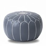 Gray leather round ottoman with white geometric stitching, handcrafted Moroccan floor pouf on white background