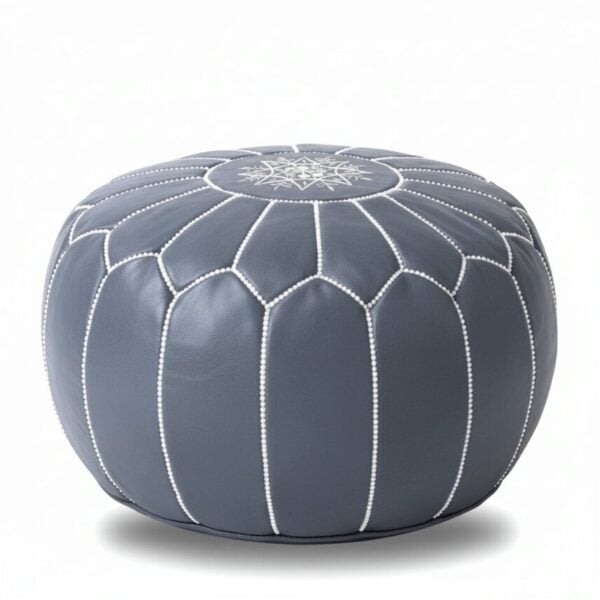 Gray leather round ottoman with white geometric stitching, handcrafted Moroccan floor pouf on white background