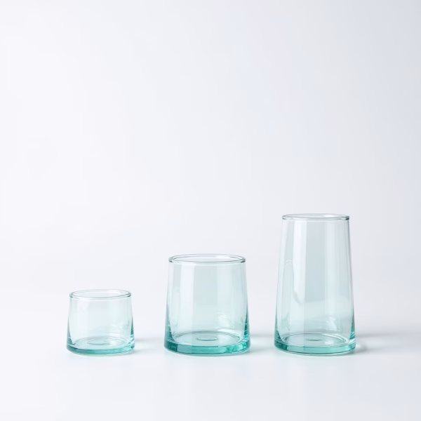 Set of three clear aqua-tinted moroccan wine glasses in graduated sizes on a bright white background.