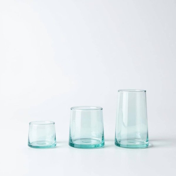 Set of three clear aqua-tinted moroccan wine glasses in graduated sizes on a bright white background.