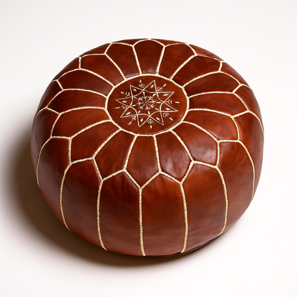 Studio shot of a leather pouf brown with detailed embroidery, highlighting the artisanal quality of Moroccan craftsmanship.