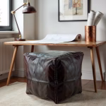 Dark brown pouf with modern desk setup