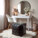 Dark leather pouf at vanity desk with mirror